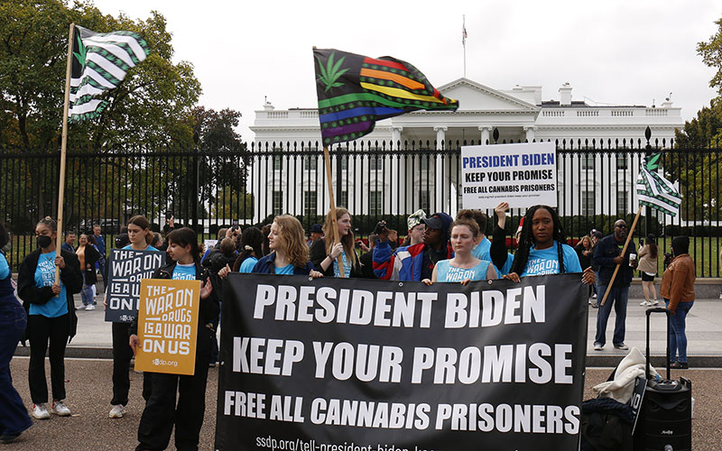 Young people protest for President Joe Biden to pardon people convicted of a federal charge of marijuana possession outside the White House gates.