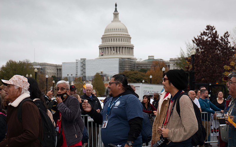 Marchers walk from the National Museum of the American Indian toward the Capitol as part of the formal dedication ceremonies on Veterans Day for the National Native American Veterans Memorial in Washington.